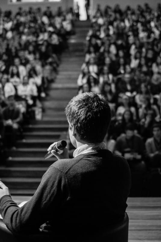 Person Speaking in front of the audience